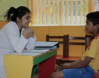 A doctor speaking with a boy during a Ramagya Foundation health check-up